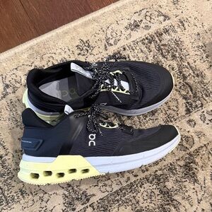 On Running Black Sneakers with Pale Yellow Heel Accents
